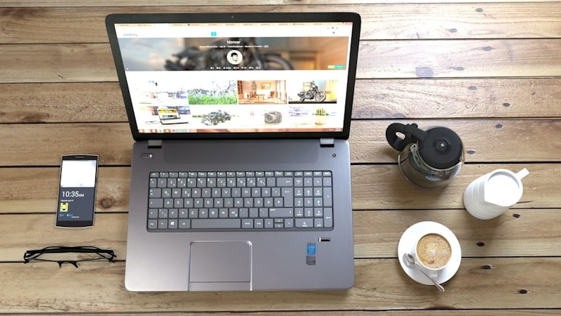 Laptop, coffee, phone, on a table