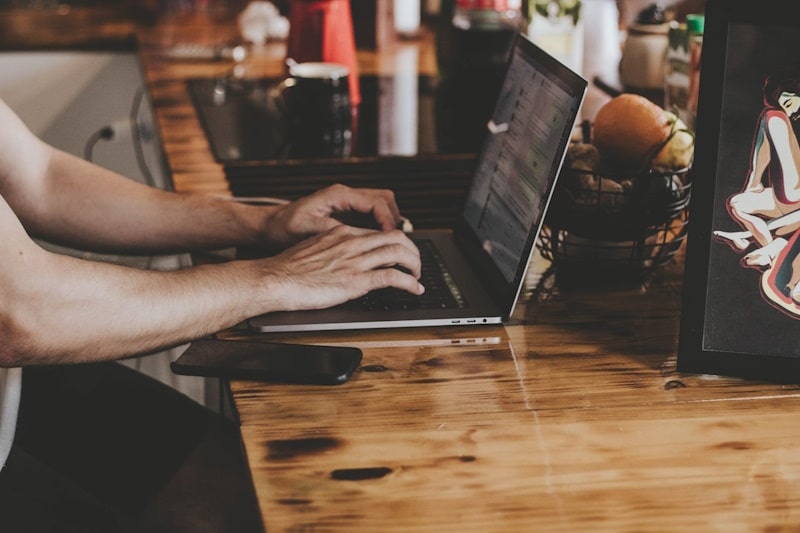 Person writing on a computer